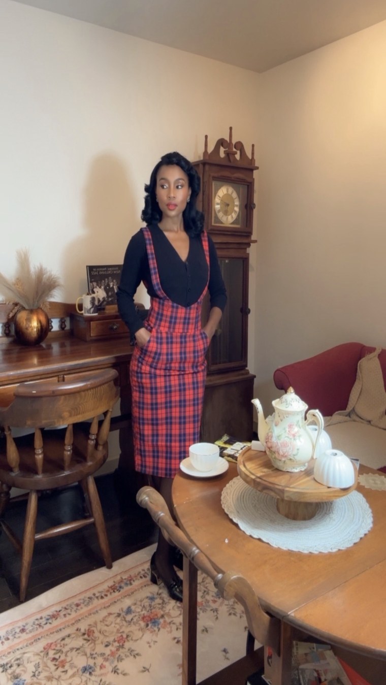 Red tartan pinafore at a tea table